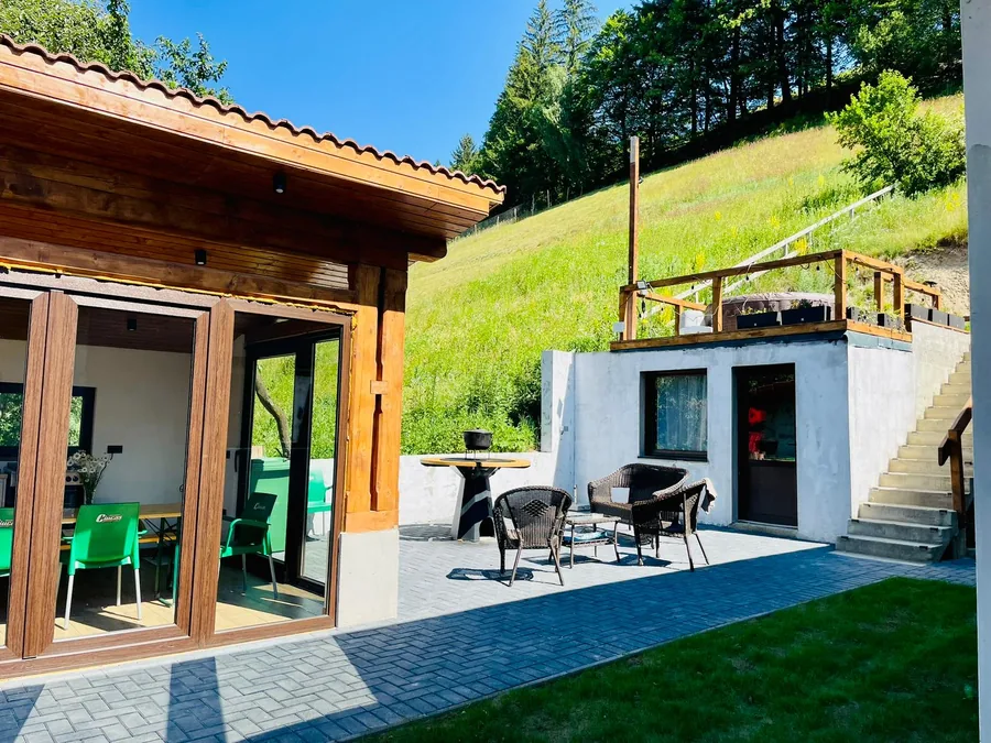 Gazebo with outdoor patio, lounge chairs and round grill